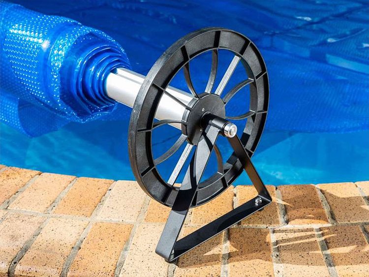 Pool Express - A pool cover roller with a partially rolled-up cover, featuring a large black wheel and triangular support frame, set against a blue background.